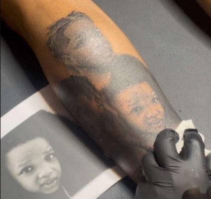 Singer Wizkid Tattoos His Children Faces On His Leg (Photos)